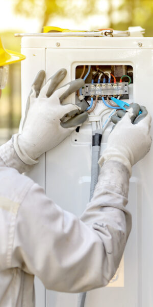 The air conditioner technician is checking the air compressor system.